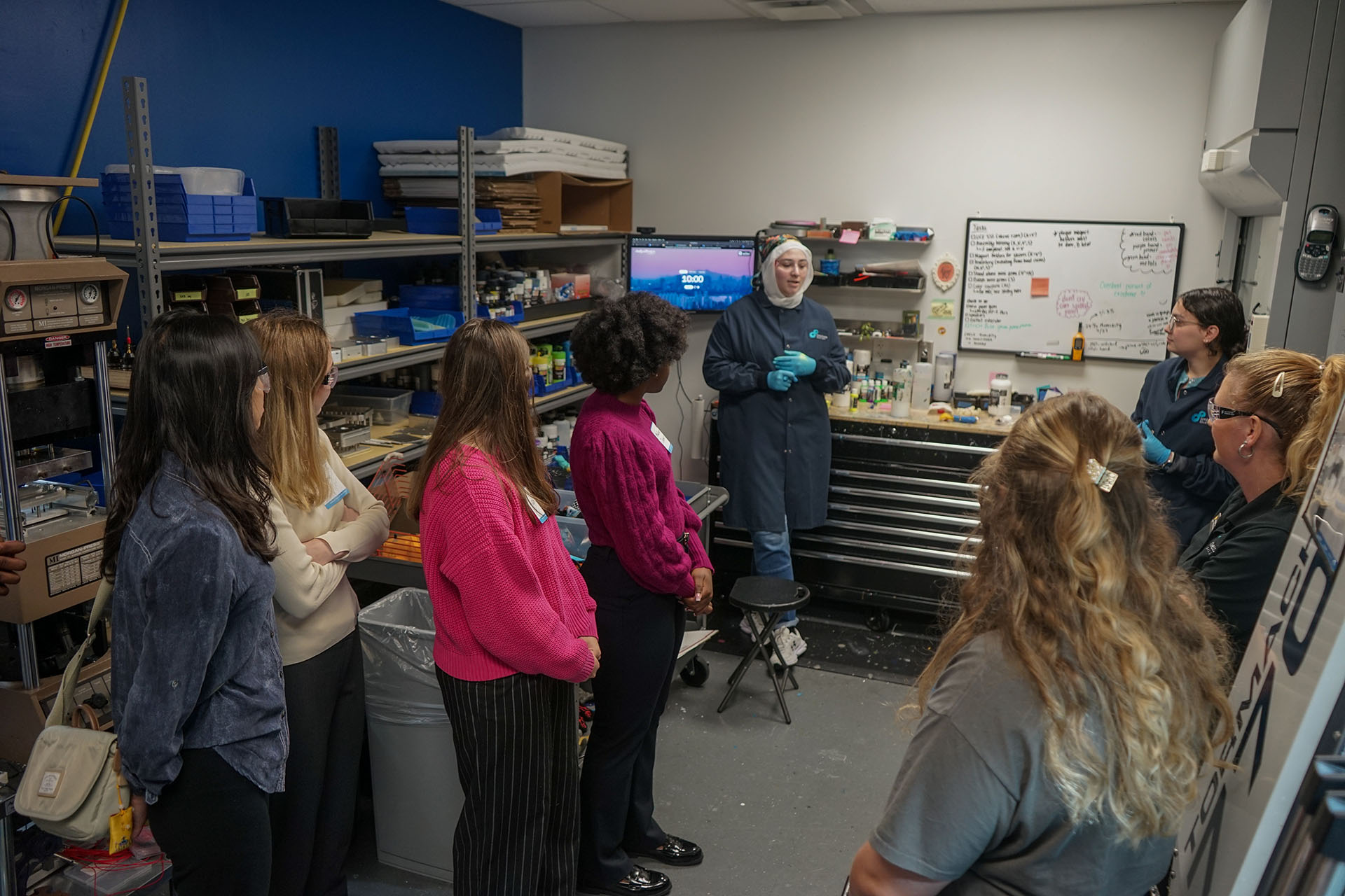 A Limbitless Student Scholar gives a tour of the paint room to a group