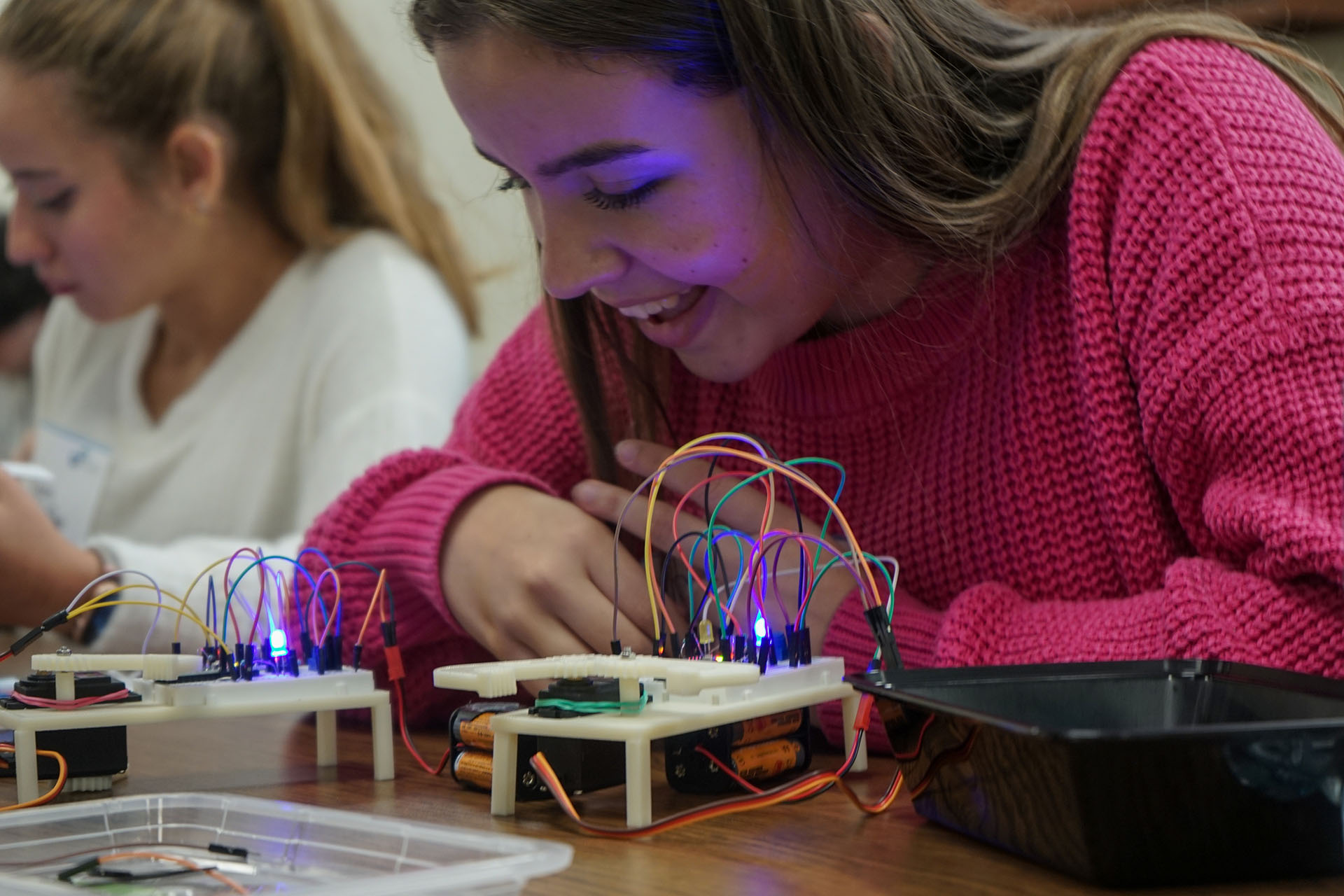 A student participating in the Limbitless ENGAGE program wires a circuitboard topped with electronics